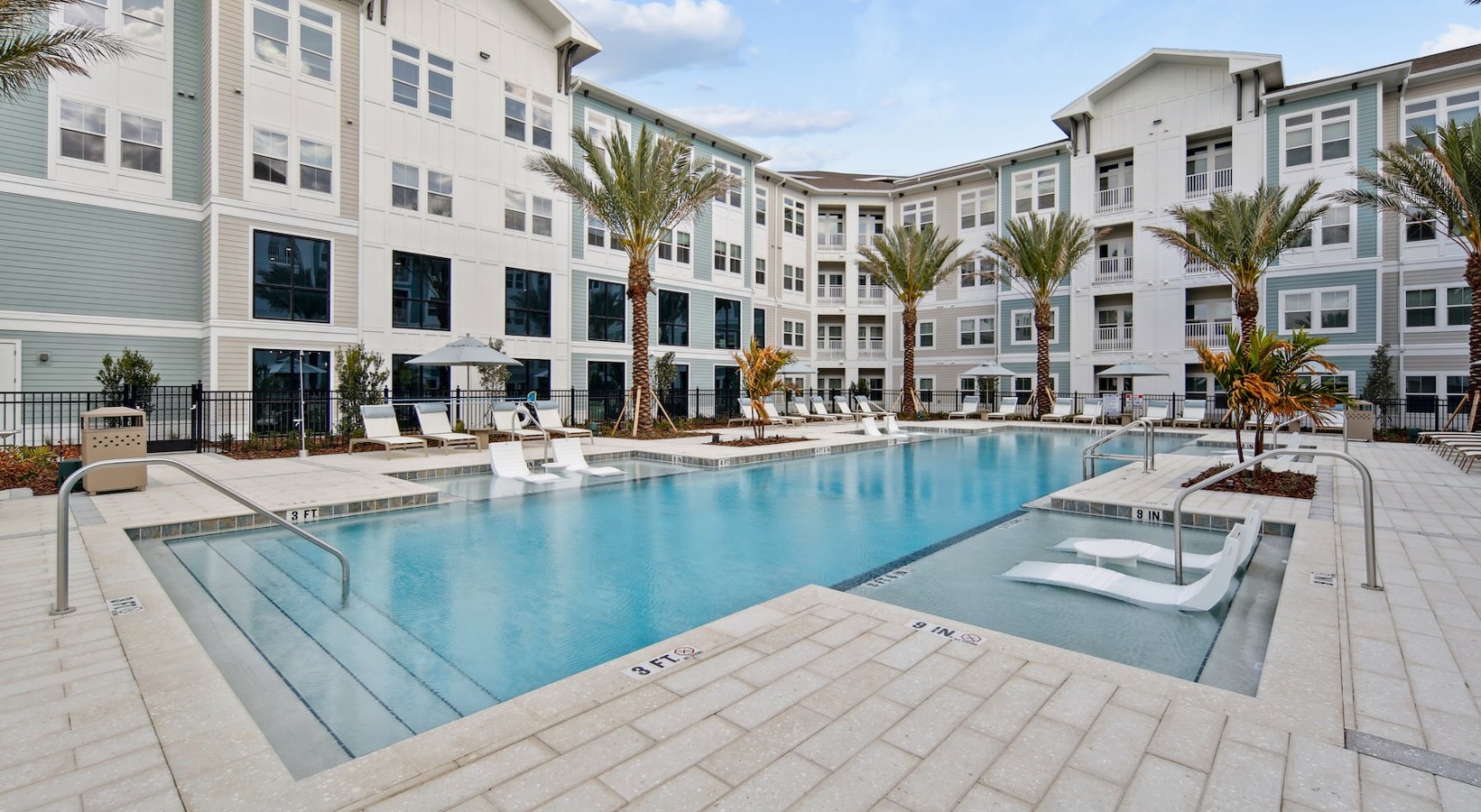 a courtyard with a swimming pool and chairs